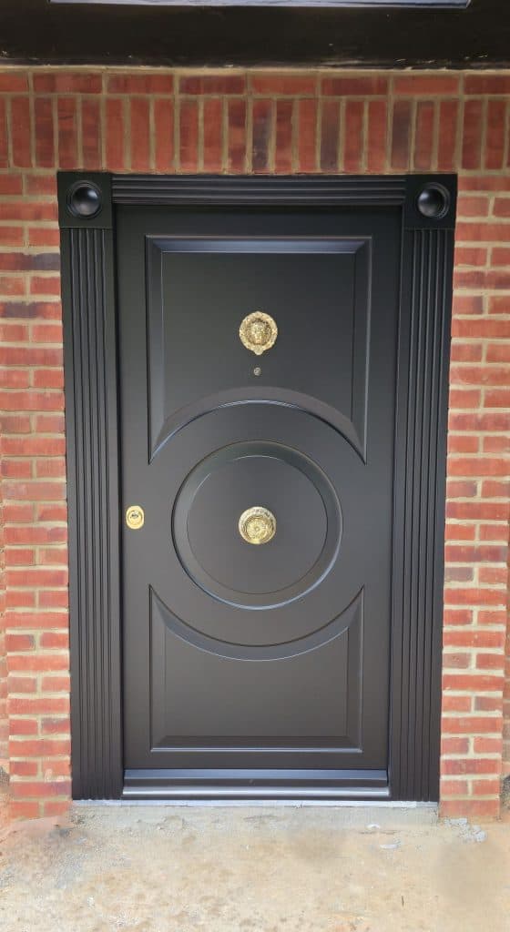 Black security door with circular design and bespoke architraves