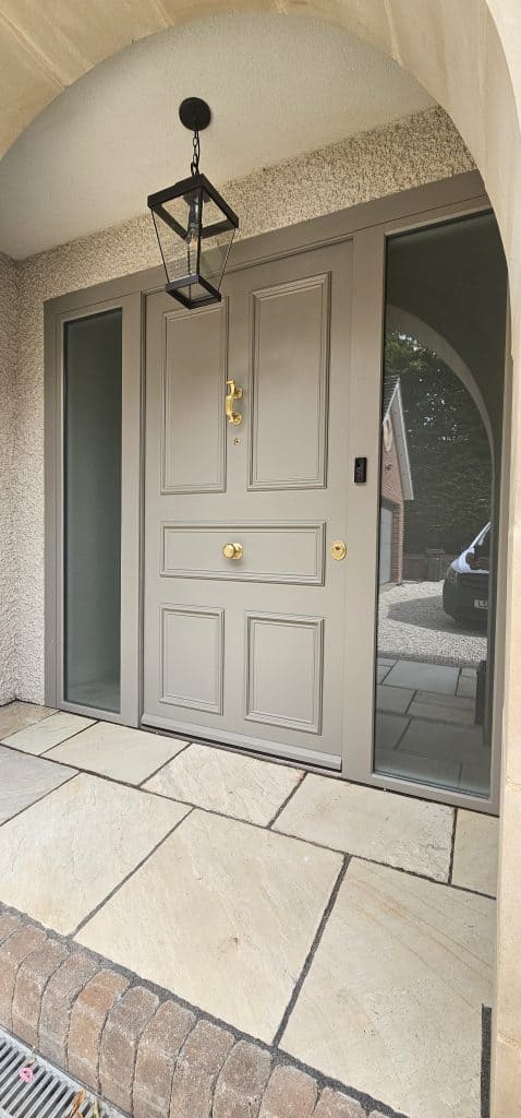 Traditional grey security door with doctor knocker and sidelights