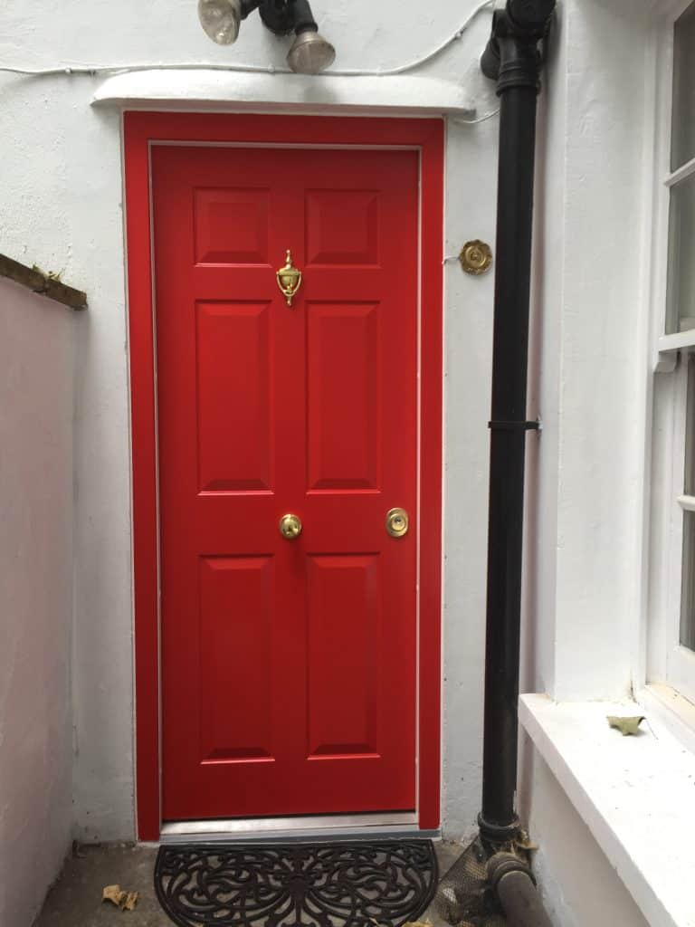 Red Level 2 security door with brass knocker